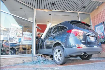  ?? JIM DAY/THE GUARDIAN ?? A 33-year-old Charlottet­own woman crashed her vehicle through the door of a city store on Kent Street after clipping a parked car Monday afternoon. Police say there were no injuries.