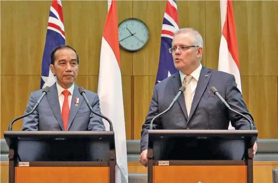  ?? Photo: AFP ?? Indonesia’s President Joko Widodo, left, and Prime Minister Scott Morrison, right, give a joint statement at Parliament House in Canberra.