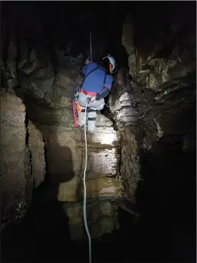  ?? (Special to the Arkansas Democrat-Gazette) ?? Ryan Spotts descends into a newly explored cave last year at Devil’s Knob Natural Area to map and inventory the cave with the help of the Cave Research Foundation. Spotts is the land management specialist/volunteer coordinato­r for the Natural Heritage Commission.