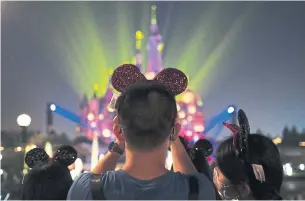  ?? HU CHENGWEI GETTY IMAGES ?? The reopening of Shanghai Disneyland is one of the largest test cases yet of whether mass gatherings can take place safely amid the virus pandemic.