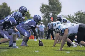  ??  ?? Billy Homer of St. Michael’s, center left, prepares to snap the ball Saturday. The Horsemen have won 12 straight matchups against the Capital Jaguars.