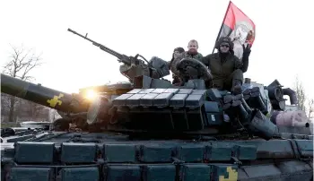  ?? ?? Ukrainian tankists greet people as they ride on a road in Kherson amid Russia’s invasion of Ukraine.