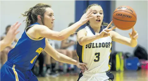  ?? JULIE JOCSAK/POSTMEDIA NEWS ?? Lauren Vanecko of the Sir Winston Churchill Bulldogs shoots the ball away from Tess Puchalski of the E.L. Crossley Cyclone at E.L. Crossley during the 14th Tribune Girls Basketball Tournament on Wednesday.