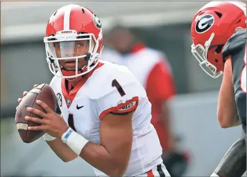  ?? John Bazemore / AP ?? Georgia quarterbac­k Justin Fields looks for an open receiver during the first half of the G day inter squad spring game.