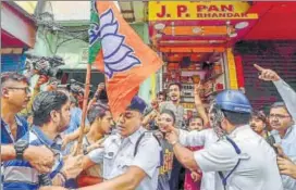  ?? PTI ?? Police personnel trying to stop BJP workers during 'Bangla Bandh' in Kolkata on Wednesday.