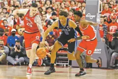  ?? JAY LAPRETE/ASSOCIATED PRESS ?? Ohio State’s Kyle Young, left, and Jamari Wheeler, right, and Duke’s Wendell Moore chase a loose ball during the first half of Tuesday’s game in Columbus, Ohio.