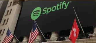  ?? (Reuters) ?? THE SPOTIFY LOGO hangs on the facade of the New York Stock Exchange earlier this month.