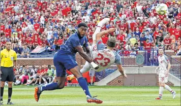  ??  ?? Liverpool’s Xherdan Shaqiri (R) shoots and scores during the Internatio­nal Champions Cup match against Manchester United.