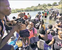  ??  ?? Fresh wave: Haitian migrants are flooding in to a Del Rio, Texas encampment, adding to a border crisis that’s exposing thousands to danger.