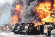  ?? ASSOCIATED PRESS ?? Vehicles are on fire at an oil depot after missiles struck the facility in an area controlled by Russian-backed separatist forces 94 miles from Donetsk in eastern Ukraine.