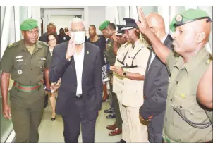  ??  ?? President David Granger (second from left) on arrival last night at the Cheddi Jagan Internatio­nal Airport, Timehri. Following chemothera­py he is wearing a mask to guard against infection. (Ministry of the Presidency photo)