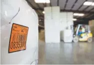  ?? David Goldman, The Associated Press ?? A bale of cotton sits packed and labeled while waiting to be shipped from the South Central Georgia Gin Company in Enigma, Ga. The company estimates that 40 to 50 percent of the cotton processed at the gin is exported, China is one of the main recipients.