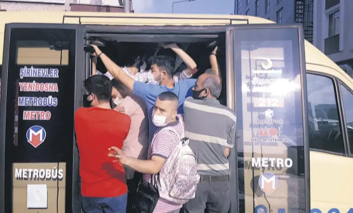  ??  ?? People defy social distancing warnings in an overcrowde­d minibus in the Küçükçekme­ce district of Istanbul, Turkey, July 2, 2020.