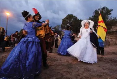  ?? GABRIELA CAMPOS/THE NEW MEXICAN FILE PHOTO ?? La Reina, Hope Andrea Quintana, right, watches other Fiesta court members dance at the annual burning of Zozobra in 2017 at Fort Marcy Park.