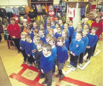  ?? ?? Pupils from St John’s and St Patrick’s Church Primary School singing in the Bridges.