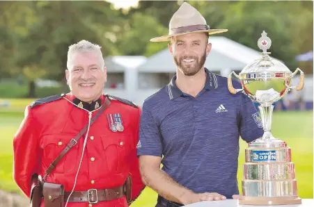  ??  ?? American Dustin Johnson dons the customary RCMP Stetson alongside a Royal Canadian Mounted Police officer after winning at Glen Abbey Golf Club in Oakville Ont., on Sunday.