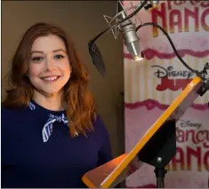  ??  ?? This March 2, photo released by Disney Junior shows Alyson Hannigan, who voices the character Claire Clancey for the animated series “Fancy Nancy,” at a recording session in Los Angeles.
PAuL HEBERT/DISnEY JunIOR VIA AP