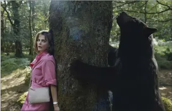  ?? PAT REDMOND — UNIVERSAL PICTURES VIA AP ?? Keri Russell does her best to avoid a bear in a scene from “Cocaine Bear,” directed by Elizabeth Banks.