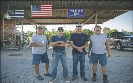  ?? (AP/Wong Maye-E) ?? Jim Rainbolt (from left), 57; Rick Warren, 65; Bill Stevens, 76; and Roger Plott, 65, stand outside The Gunsmoke Club in West Vienna, Ill. Their clubhouse, a few miles outside Vienna, is an old gas station, later turned into a convenienc­e store and now a gathering place for a dozen or so friends. It’s part workshop, part bar, part informal store.