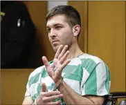  ?? SETH WENIG / AP ?? Anthony Comello displays writing on his hand during his extraditio­n hearing in Toms River, N.J. Comello is accused of killing the reputed boss of New York’s Gambino crime family, Francesco ‘Franky Boy’ Cali.