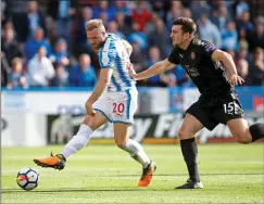  ??  ?? TURN AND FIRE: Laurent Depoitre outwits Harry Maguire to score a stunning opening goal for Huddersfie­ld moments after the break