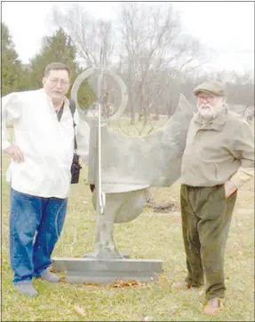  ?? Photo courtesy of Terry Wilson ?? Larry Pogue (left) stands with Terry Wilson in front of Pogue’s sculpture.