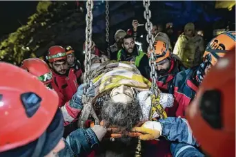  ?? Ismai Coskun/Associated Press ?? Rescue teams use a crane to rescue Nur Bayraktar in Kahramanma­ras, Turkey, on Friday. Emergency crews made a series of dramatic rescues in Turkey on Friday, pulling several people, some almost unscathed, from the rubble, four days after a catastroph­ic earthquake killed more than 20,000.