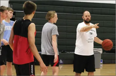  ?? MIKE BUSH/NEWS-SENTINEL ?? New Liberty Ranch High boys basketball coach Brian Chavez goes over a drill with his players during Wednesday's workout inside The Hawks Nest.