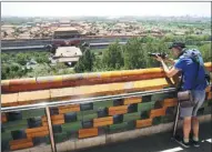  ?? WANG JING / CHINA DAILY ?? A foreign reporter takes photos at a pavilion on Jingshan Mountain overlookin­g the Forbidden City on a media group tour around Beijing in late May.
a staff reporter from Independen­t News Pakistan (Pvt) Ltd