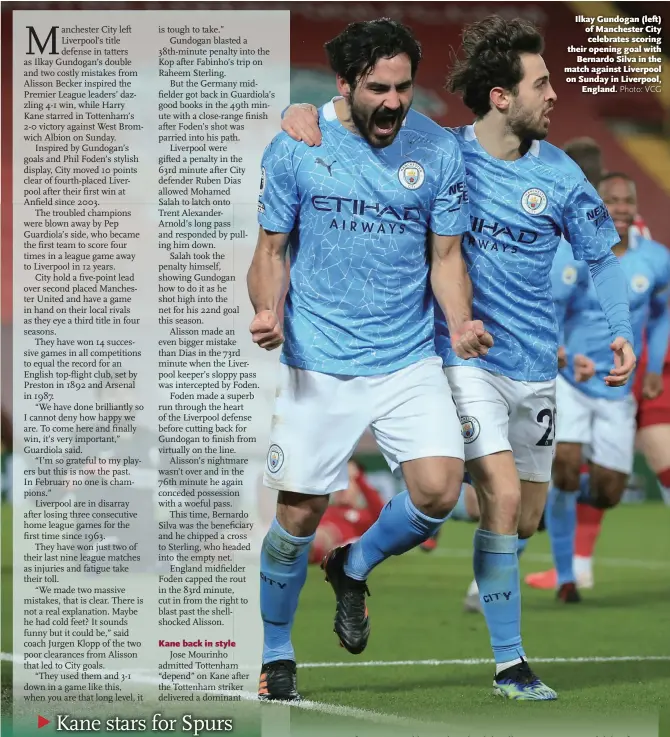  ?? Photo: VCG ?? Ilkay Gundogan ( left) of Manchester City celebrates scoring their opening goal with Bernardo Silva in the match against Liverpool on Sunday in Liverpool, England.