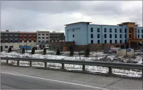  ?? BILL DEBUS — THE NEWS-HERALD ?? This Jan. 11photo shows progress being made on constructi­on of two new hotels — The Hampton Inn (foreground) and Holiday Inn Express and Suites — being built near the Interstate 90and Route 528interch­ange in Madison Village.