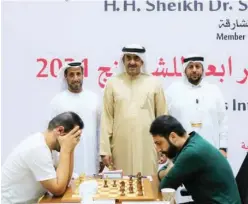  ??  ?? ↑
Salem Abdulrahma­n Mohamed Saleh (right) ponders a move against Niemann Hans Moke as Sheikh Saud Bin Abdulaziz Al Mualla and Omar Noman Al Ali look on.