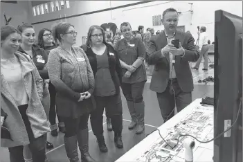  ?? CARLA ALLEN ?? Derek Fitzgerald with Deloitte, describes futuristic technology to NSCC students during the Nov. 16 Entreprene­urship Expo.