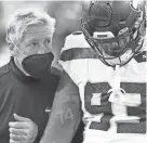  ?? RICH BARNES/USA TODAY SPORTS ?? Seahawks coach Pete Carroll talks with defensive end Jonathan Bullard after the team’s loss to the Bills.