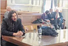  ?? DOUGLASS DOWTY THE ASSOCIATED PRESS ?? Michael Rotondo, left, sits during an eviction proceeding in Syracuse, N.Y., brought by his parents, Mark and Christina. The two parents confer with their lawyer, Anthony Adorante, in the court gallery behind.