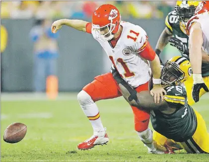  ?? THE ASSOCIATED PRESS ?? The Kansas City Chiefs’ Alex Smith (11) fumbles as he is sacked by the Green Bay Packers’ Mike Daniels during the second half of the teams’ game Monday in Green Bay, Wis. Smith was sacked seven times in the game, making it 13 on the season. The Chiefs...