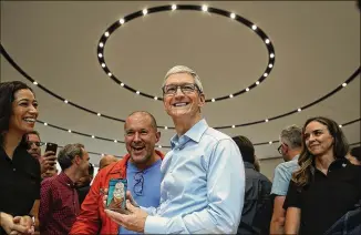  ?? JUSTIN SULLIVAN / GETTY IMAGES ?? Apple CEO Tim Cook (center), joined by chief design officer Jonathan Ive and other employees, unveils the iPhone X during an event Tuesday at the Steve Jobs Theater in Cupertino, Calif.