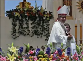  ?? THE ASSOCIATED PRESS ?? Osornos Bishop Juan Barros smiles Thursday as he leaves the altar after Mass was celebrated by Pope Francis on Lobito Beach in Iquique, Chile.