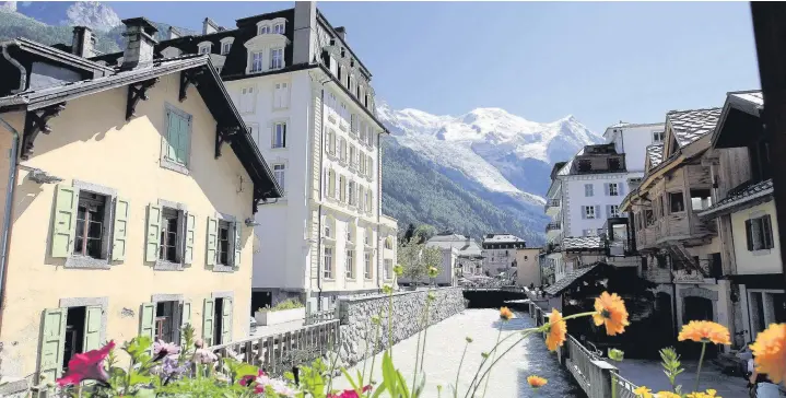  ??  ?? ●● The picturesqu­e village of Chamonix, above, and Paul enjoys the view from ‘the glass box’ at 3,842m, below