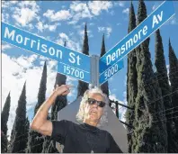  ?? AP PHOTO ?? John Densmore shows the new street sign during the second annual “Day Of The Doors” event in Encino, Calif., on Thursday. Los Angeles city council member Paul Koretz unveils an intersecti­ng street signs for Morrison Street and Densmore Avenue in...