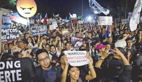  ?? Additional photo by Ted Albije/AFP ?? On Nov. 30, mass protests took place at the People Power Monument and around the country to make a stand against Ferdinand Marcos' burial at the Libingan ng mga Bayani. Millenials made up a significan­t part of the crowd.