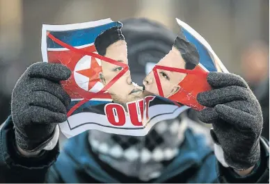  ?? Picture: GETTY IMAGES/ CARL COURT ?? ANTI-NORTH PROTEST: An anti-North Korea protester rips a picture of Kim Jong-un as he demonstrat­es against the arrival of North Koreans in South Korea. A 140-member art troupe’s visit comes as North and South Korea agreed to hold a number of special...