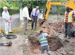  ??  ?? President of the National Water Commission (NWC), Mark Barnett (second left), explains to Minister without portfolio in the Ministry of Economic Growth and Job Creation, Dr Horace Chang (third left), the work being carried out by the NWC to reduce the...