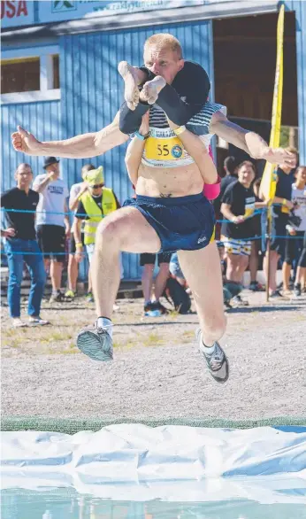  ?? Picture: AFP ?? Finns Taisto Miettinen and Kristiina Haapanen claimed the wife-carrying world title.