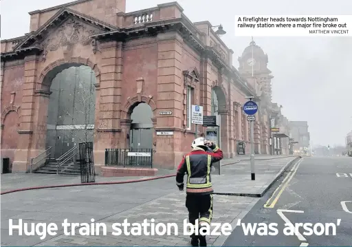  ?? MATTHEW VINCENT ?? A firefighte­r heads towards Nottingham railway station where a major fire broke out