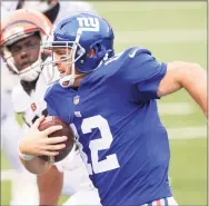  ?? Justin Casterline / Getty Images ?? The Giants’ Colt McCoy carries the ball against the Bengals last week.