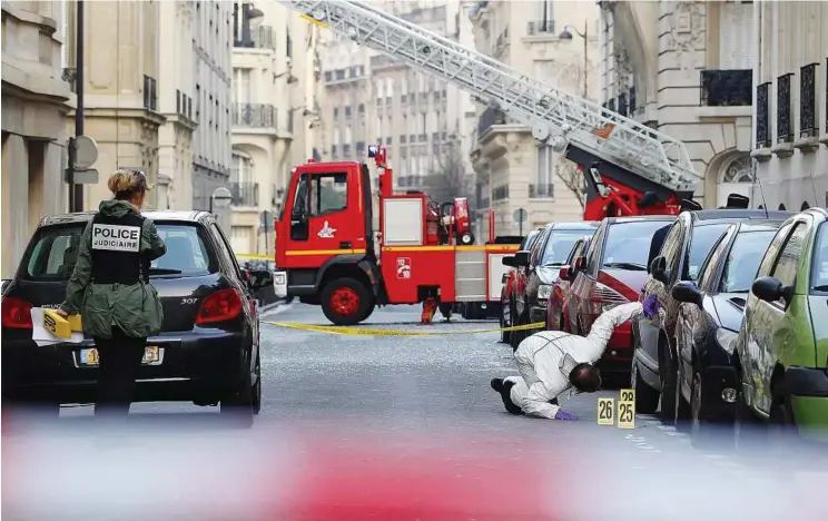  ??  ?? Bombing probe: Police conducting their investigat­ions outside the Indonesian embassy where a package bomb exploded in Paris. The package was discovered by an embassy employee who removed it from the building in Rue Cortambert. Report on Page 42. — EPA