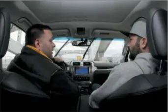  ?? JULIO CORTEZ - THE ASSOCIATED PRESS ?? Lenny Sciascia, left, talks with his friend Mario DeAngelis as they cross the Bayonne Bridge in Bayonne, N.J., on their way to place online bets on their smartphone­s in New Jersey.