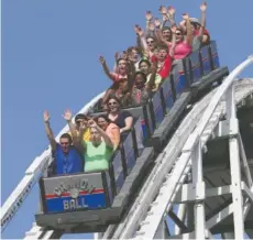  ?? ?? Guests at Lake Winnepesau­kah Amusement Park ride the Cannon Ball roller coaster in Rossville, Ga.