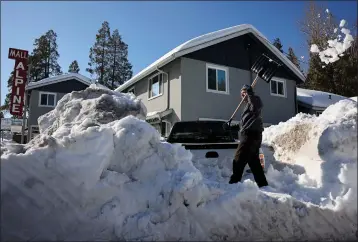  ?? MARIO TAMA — GETTY IMAGES ?? A resident shovels snow Friday after a series of winter storms dumped heavy snowfall in the San Bernardino Mountains in Southern California.